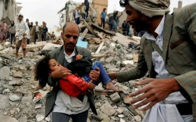 A father rescuing his daughter from airstrikes in Yemen.