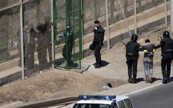 A group of immigrants entering the CIE of the Zona Franca of Barcelona.