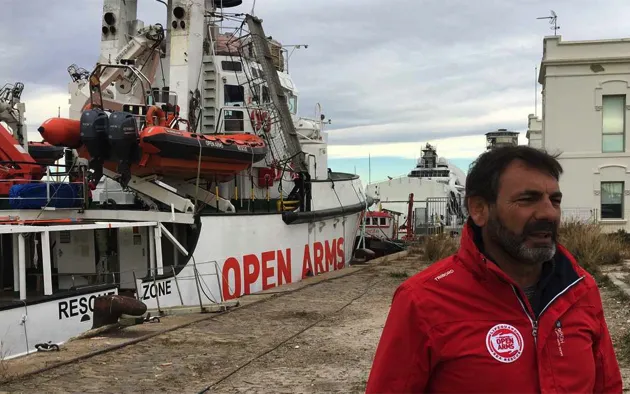 Òscar Camps in front of the Open Arms tied to the port of Barcelona on Monday.