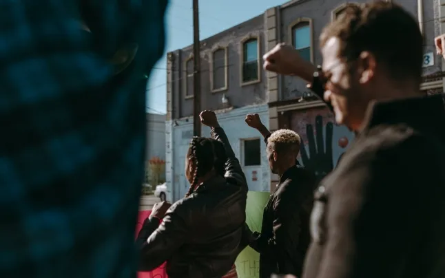 A group of people in a protest to demand the defense and protection of human rights .