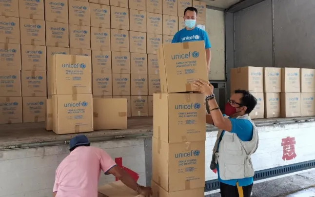 UNICEF humanitarian emergency personnel organizing supplies shipped to the Philippines.