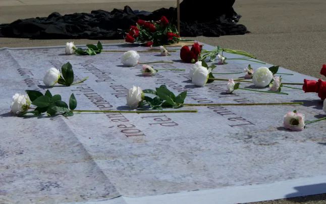 Campaign activists have unfurled a tarp with the names of the 1,138 victims.