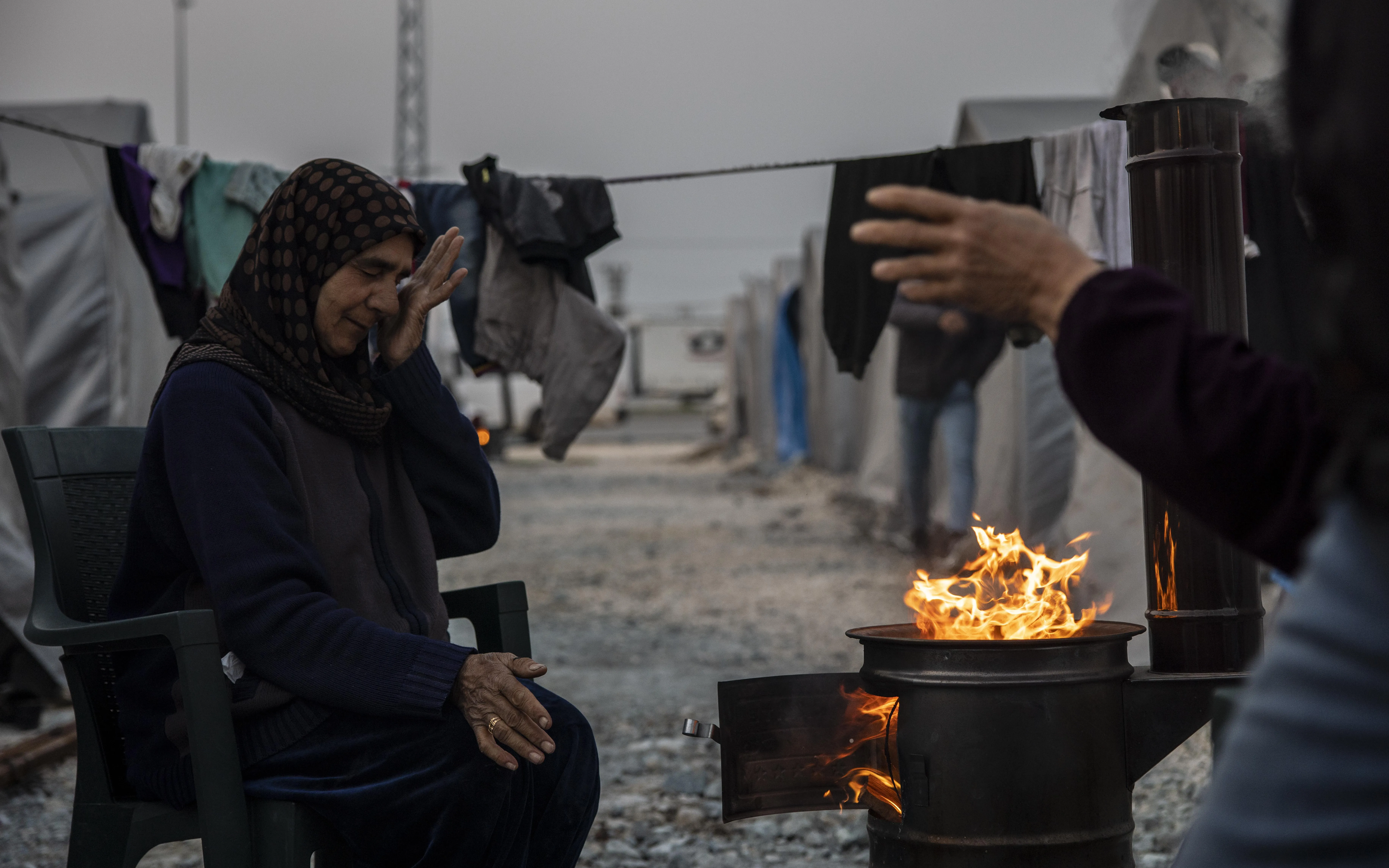 Syrian refugees light wood fires by night and burn plastic to stay warm. Many received medical services from DDD/MDM in a camp in Hatay on Friday, March 3, 2023.