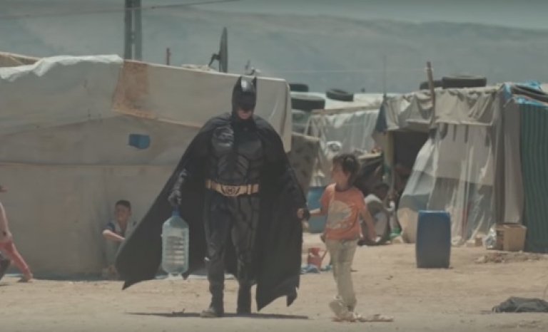 Batman visiting a refugee camp. Photo: Youtube