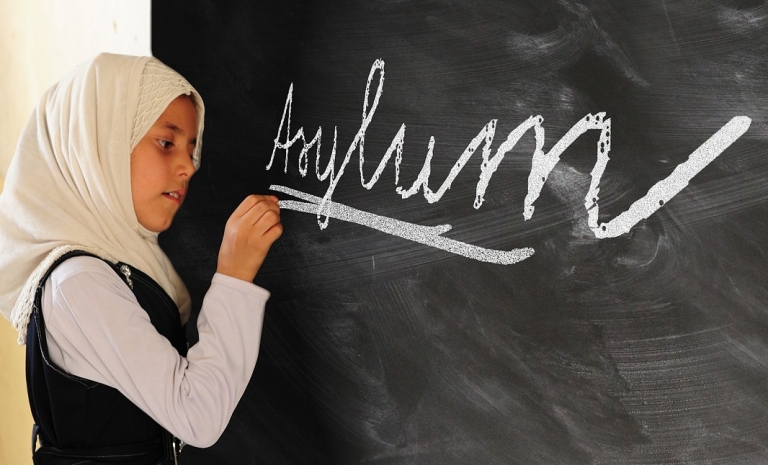 Girl writing "Asylum".