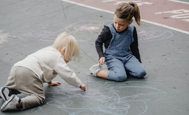 Kids drawing on the floor. 