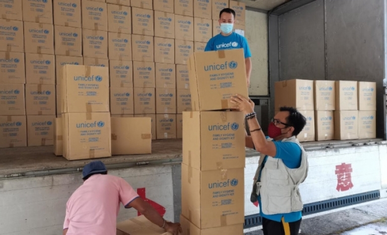UNICEF humanitarian emergency personnel organizing supplies shipped to the Philippines.