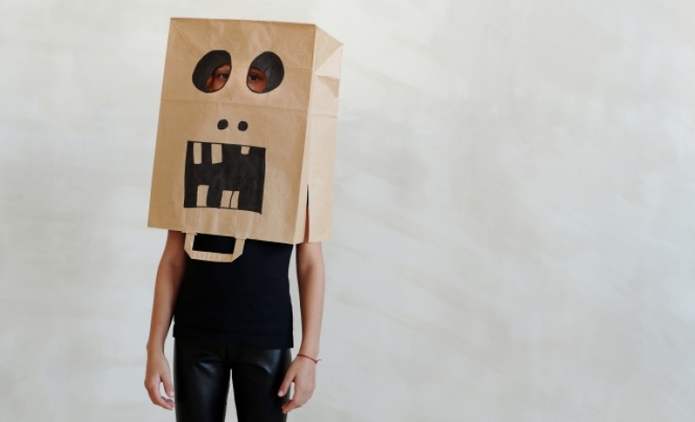A person with a paper bag on his head.